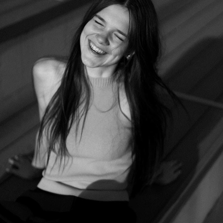 Aanya Rao, Lead Design Curator at LinenCobaltSkyline, reviewing corporate floral arrangements